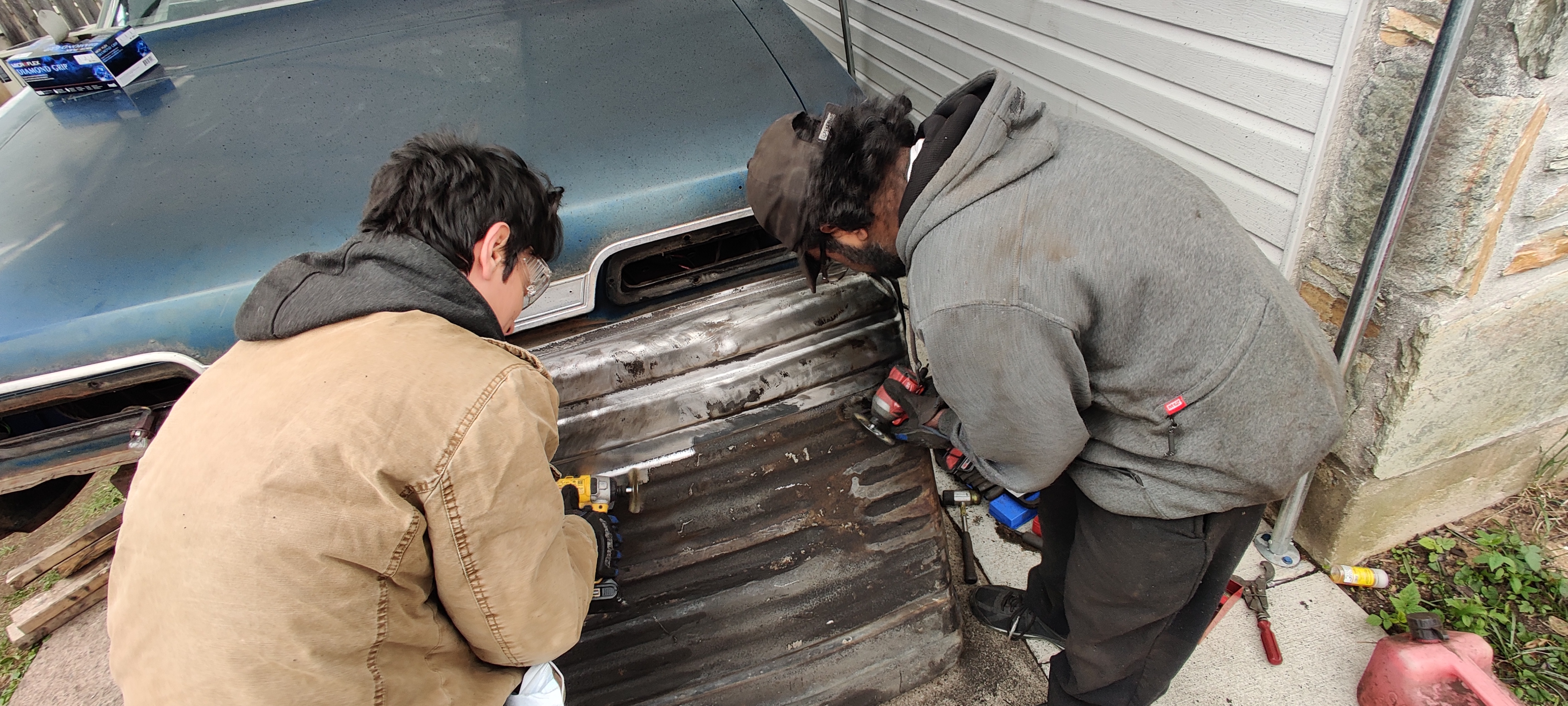 Anthony and Stephen work on cleaning the surface rust